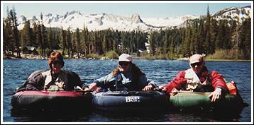 Karen and Mike Martin in belly boats in Sierra Mountain stream